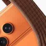 iPhone Pocket short strap in cinnamon holding iPhone 17 Pro